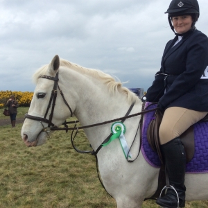 Lucy and i with our 4th place ribbon for the novice horses jumping class at a local show.